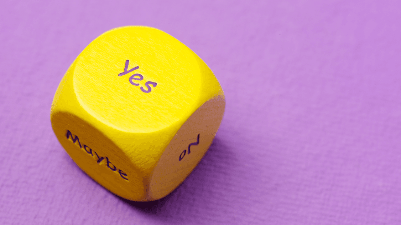 A yellow die reading ‘Yes’ against a purple background