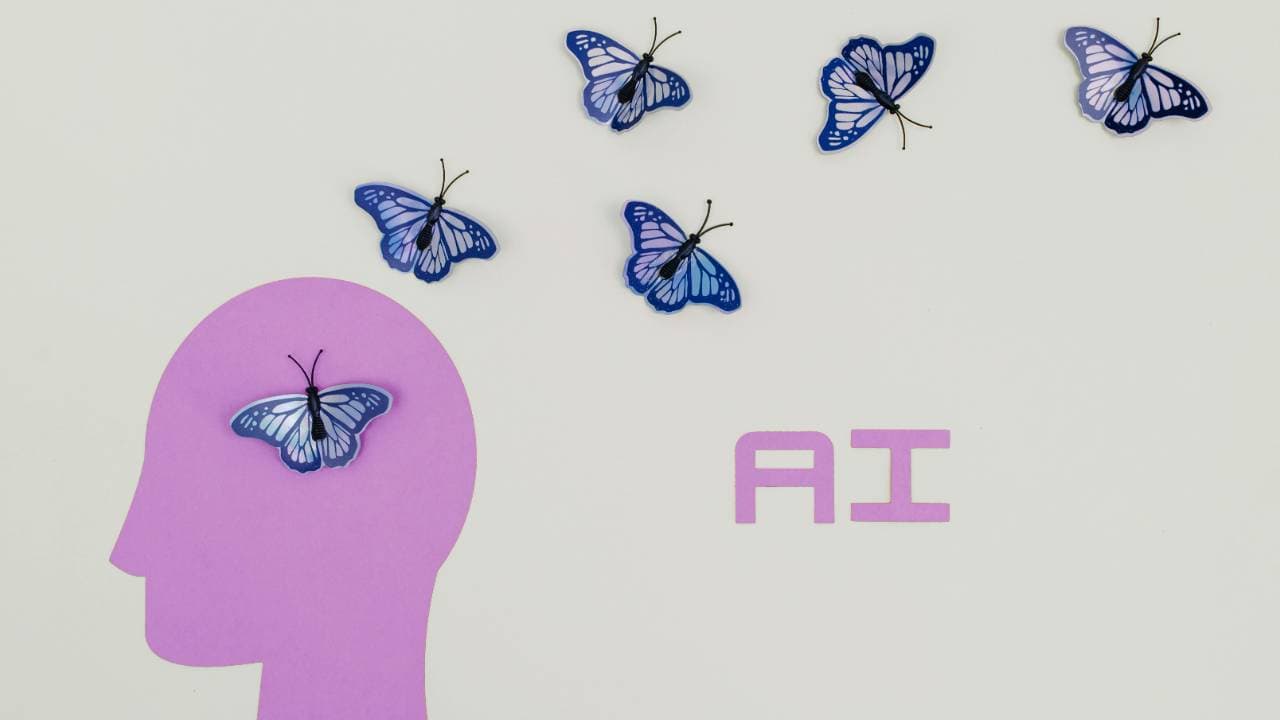 Blue paper butterflies arranged on a light background