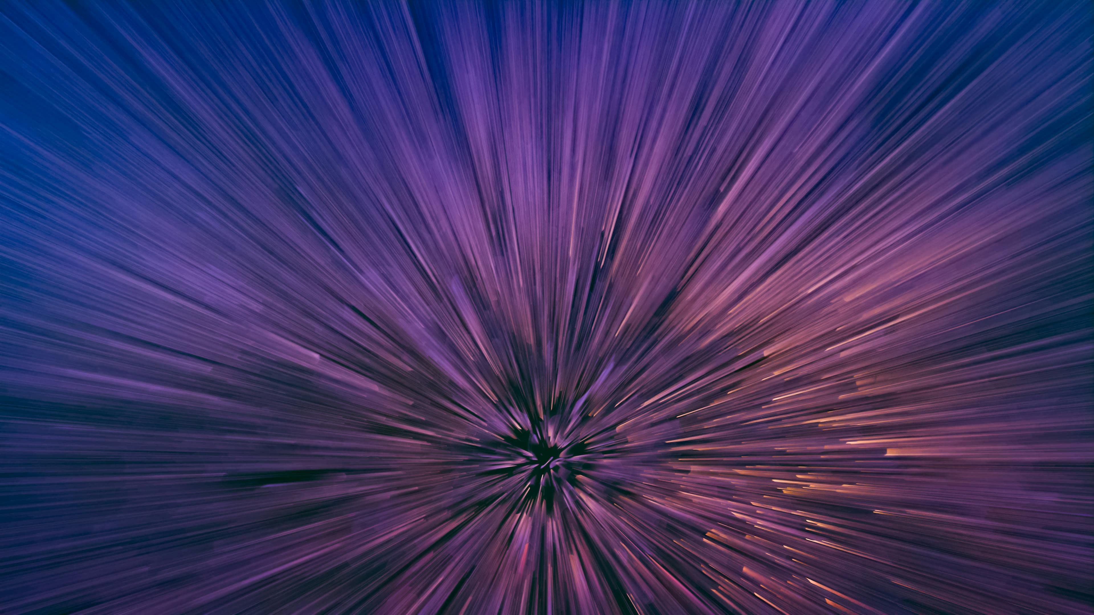 Abstract purple and blue light rays radiating outward from a central point