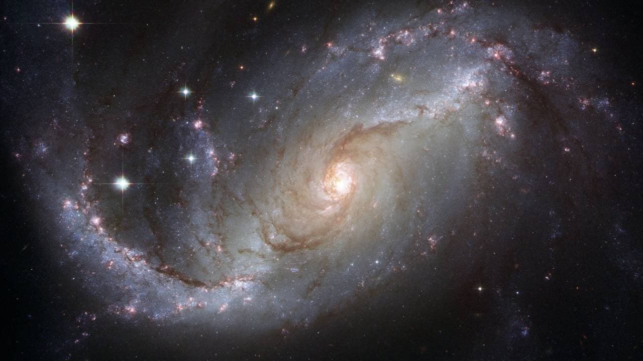 A spiral galaxy glowing against a starfield of deep space