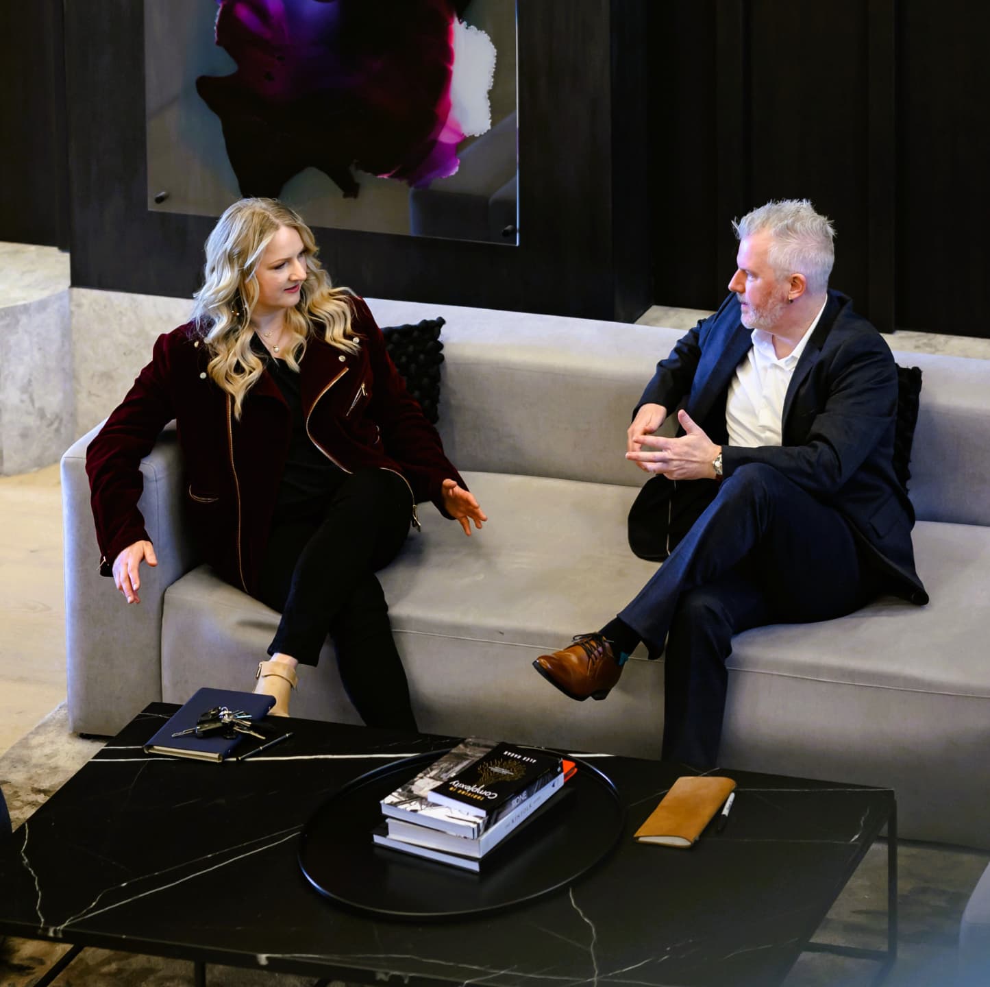 Nina Christian and Alex Hagan in conversation on a couch